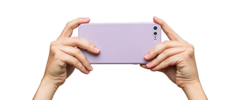 mobile-phone-with-photo-camera-in-a-lilac-case-in-female-hands-isolated-on-a-white-background