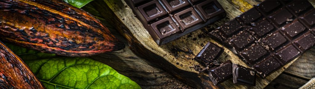 Chocolate negro en tabletas sobre una mesa de madera. 
